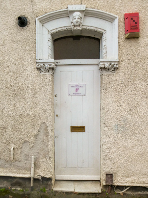 Plain white door with remains of a fancy surround, Greenbank, Bristol, February 2023